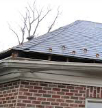 photo of a roof damaged by inclement weather